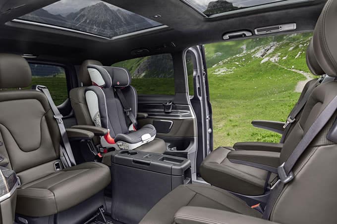 Interior of a van with passenger seats and child seat